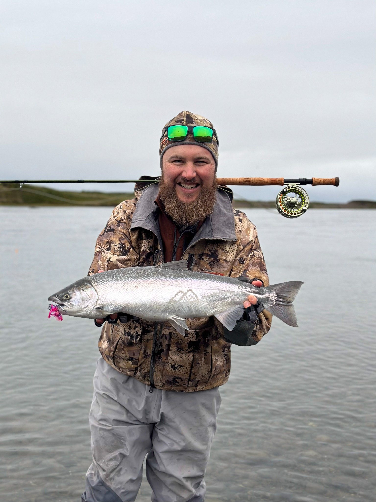 Chris Wright smiling with a silver salmon in Alaska