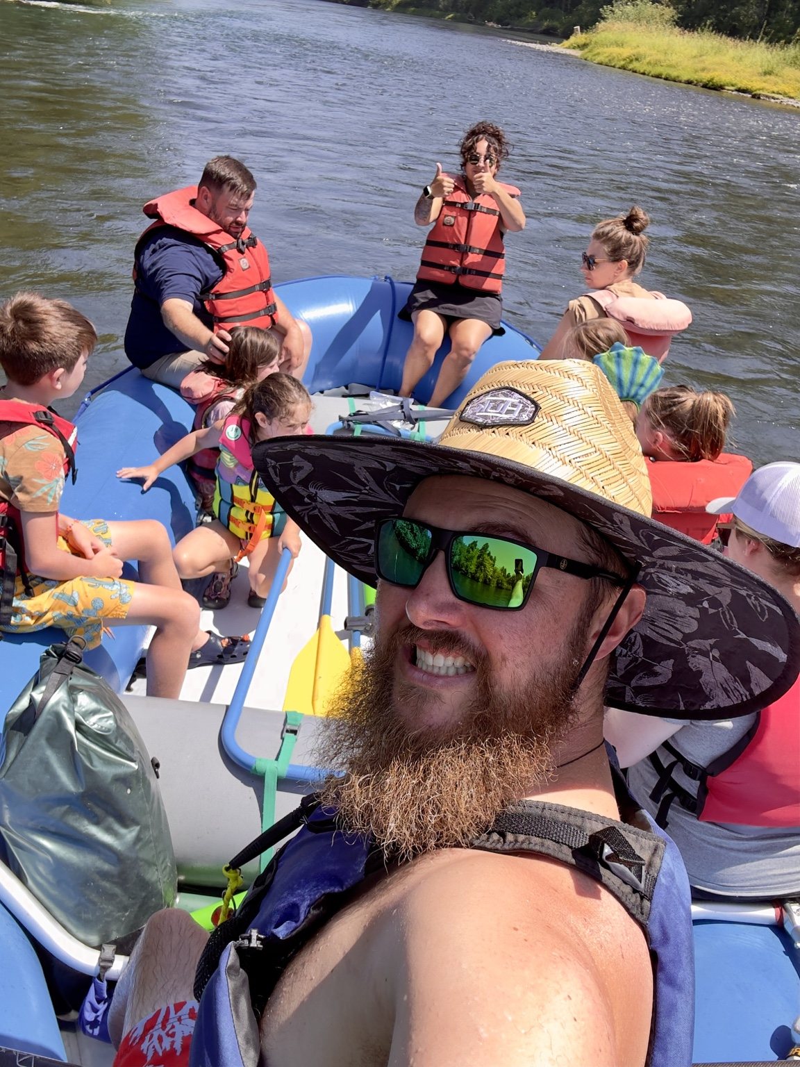 Chris and a family enjoying a rafting trip on the McKenzie River