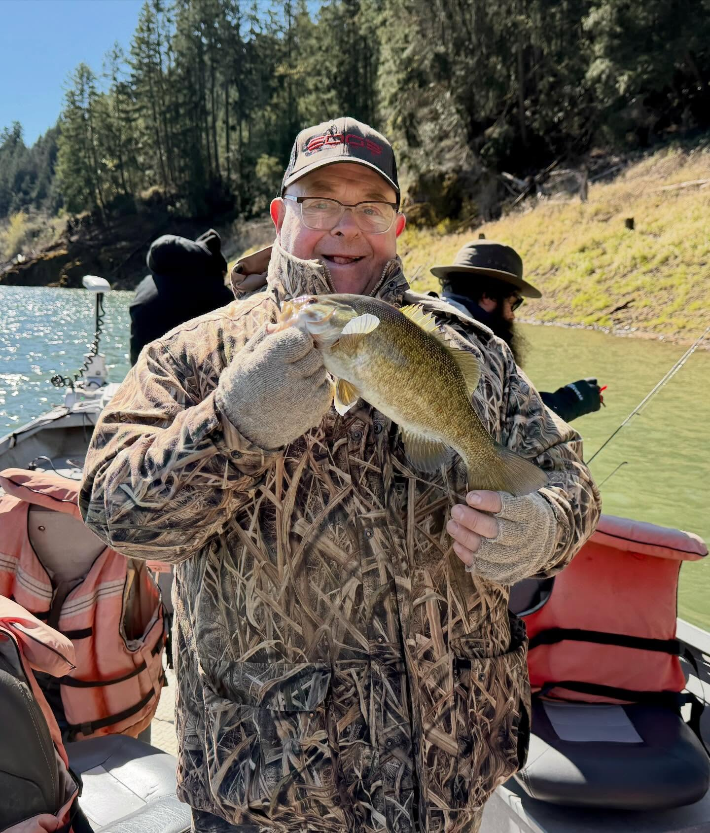 Smallmouth bass angler aboard a sled on the river